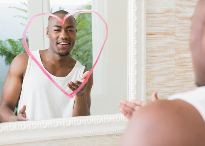 man with heart drawn on mirror