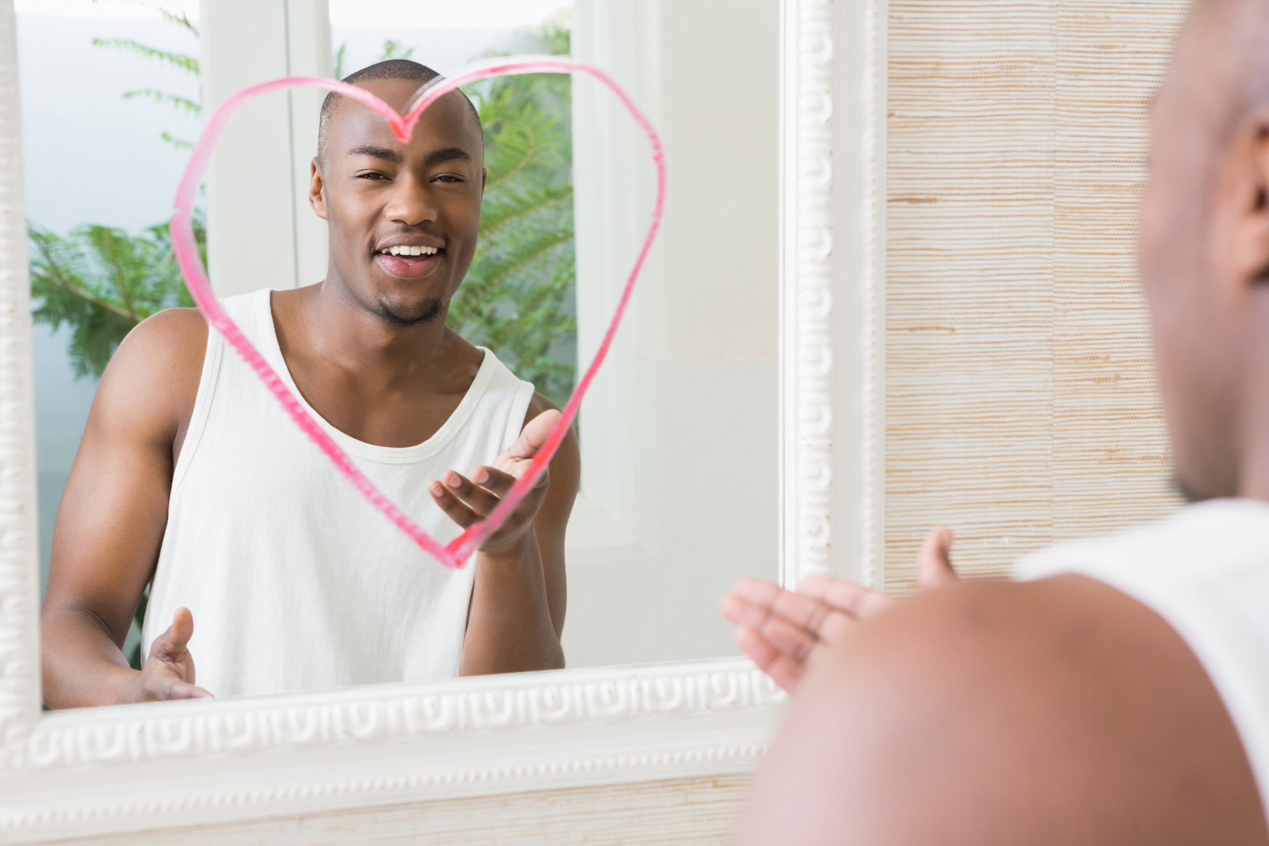 man with heart drawn on mirror